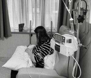 Sam in hospital having treatment whilst feeding baby